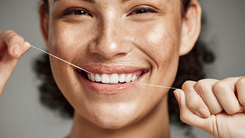 Close up shot of a woman flossing