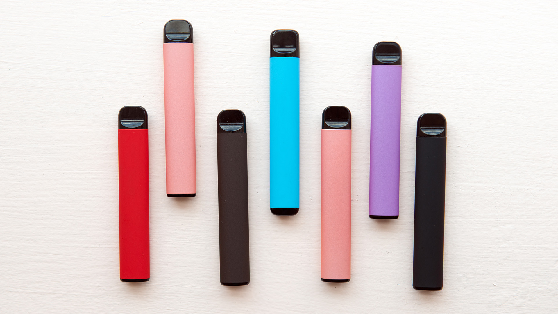 an image of a bunch of different colored handheld vapes 